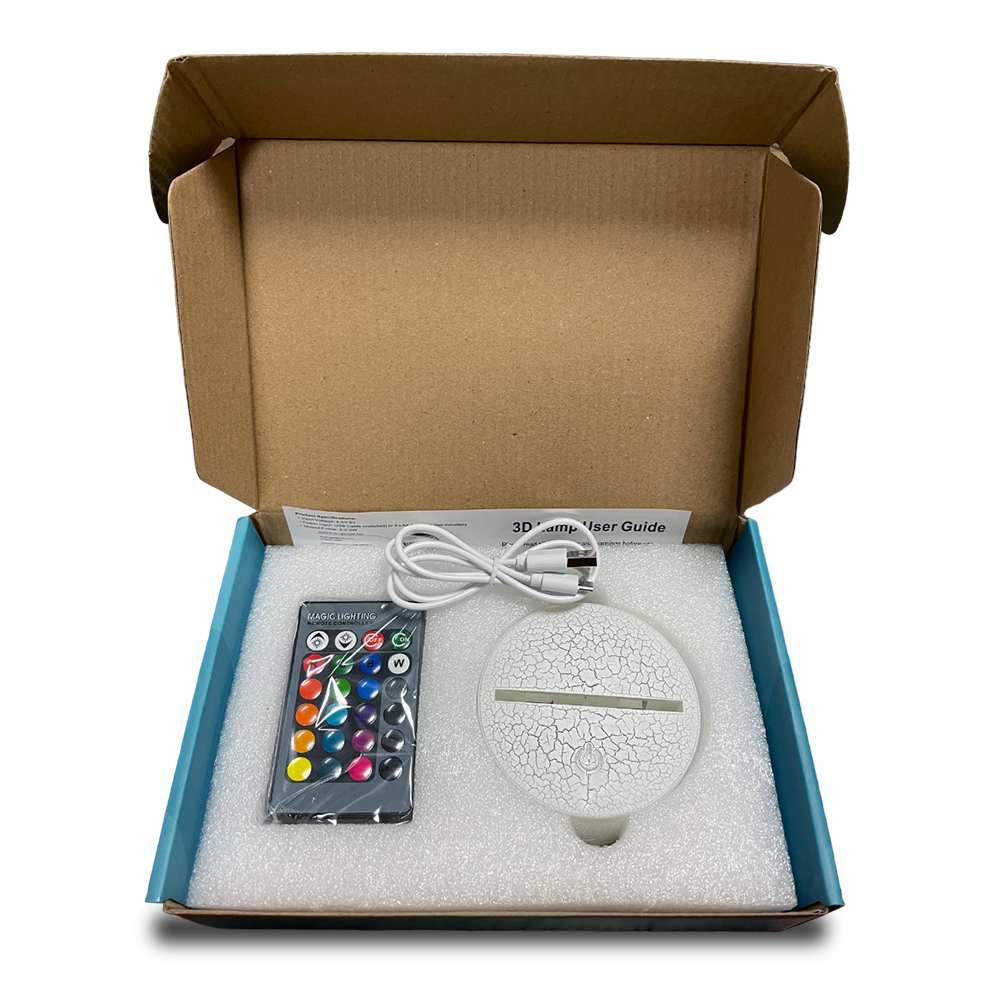 Open box of 3D light showing the control, base, and USB cable for setup.
